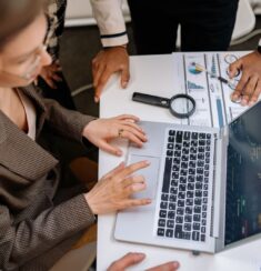 Business team comparing digital marketing performance on a laptop