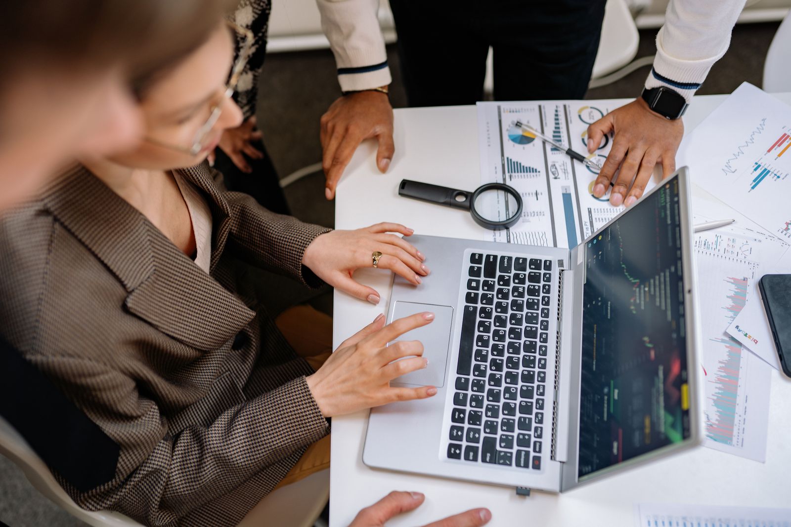 Business team comparing digital marketing performance on a laptop